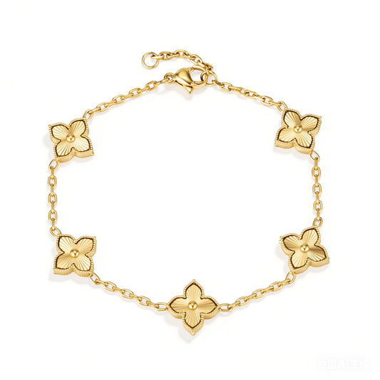 Gold bracelet featuring five gold-tone four-petal flower motifs with raised centers, shown on a white background.