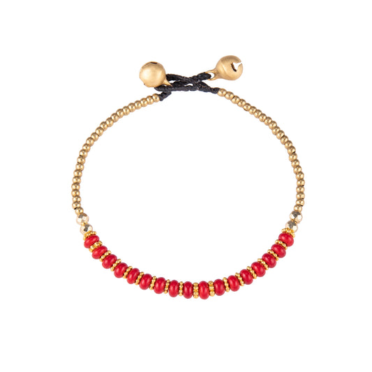 Red bracelet featuring a single row of small stone beads with gold-tone details and a sliding cord closure, shown on a white background.