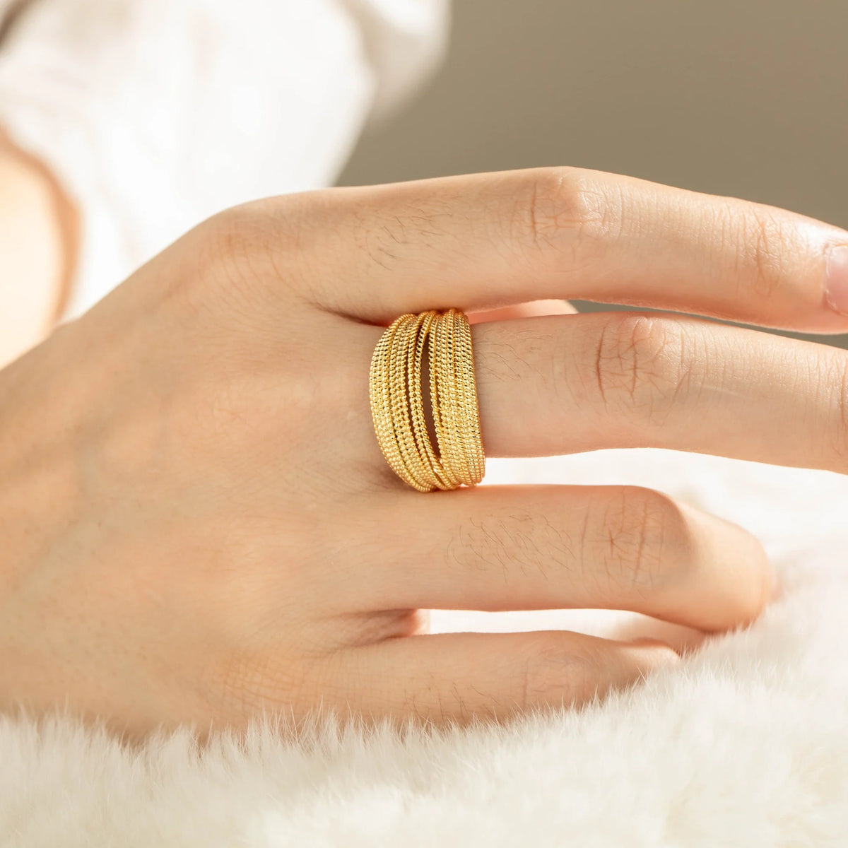 Gold-plated brass open ring shown on hand