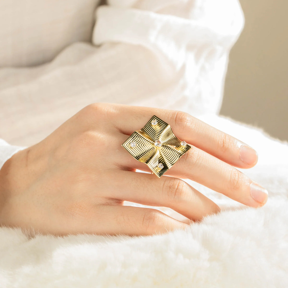 Gold-plated brass open ring shown on hand