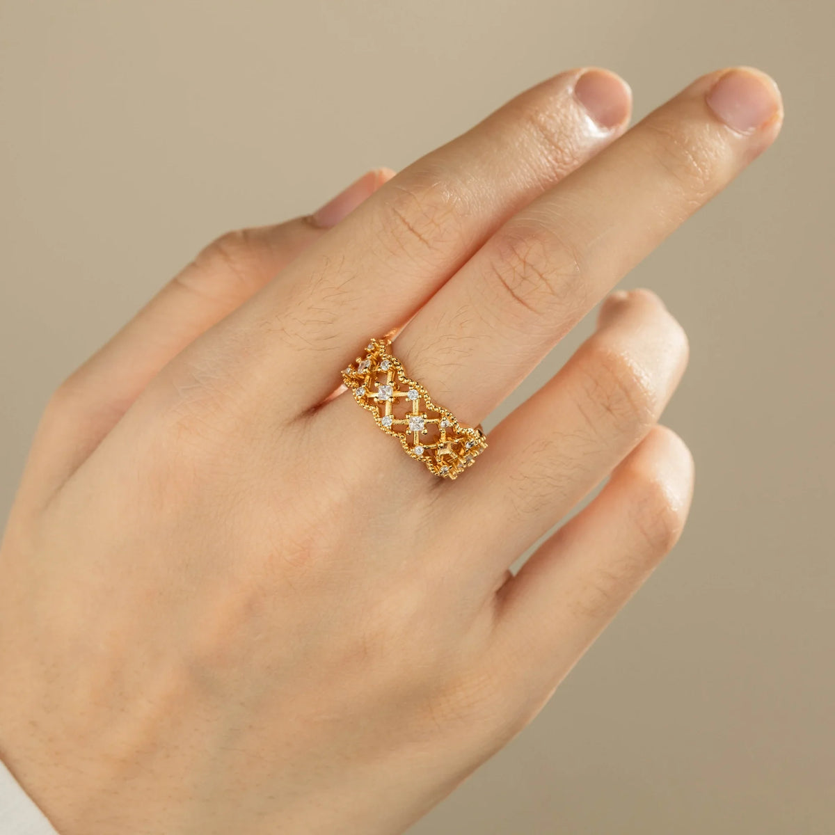 Gold-plated brass open ring shown on hand