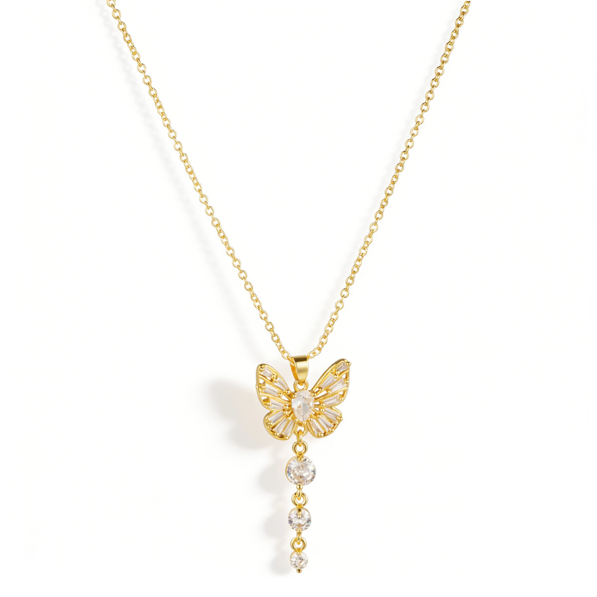 Gold necklace featuring a butterfly-shaped pendant with clear accents and a graduated dangling detail, shown on a white background.