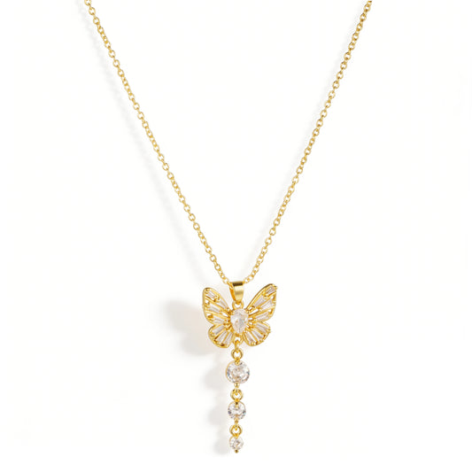 Gold necklace featuring a butterfly-shaped pendant with clear accents and a graduated dangling detail, shown on a white background.