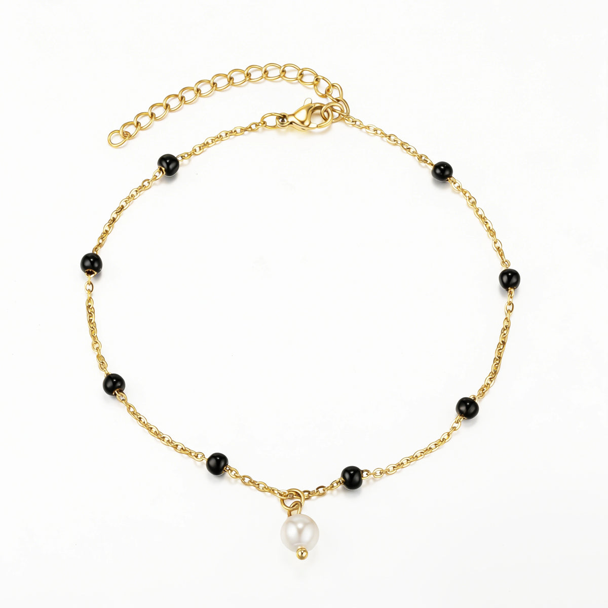 Gold and Black bracelet featuring black bead stations and a single white drop accent, shown on a white background.