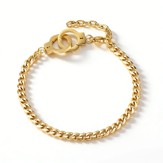 Gold bracelet featuring a curb-link chain with a paired handcuff-shaped connector, shown on a white background.