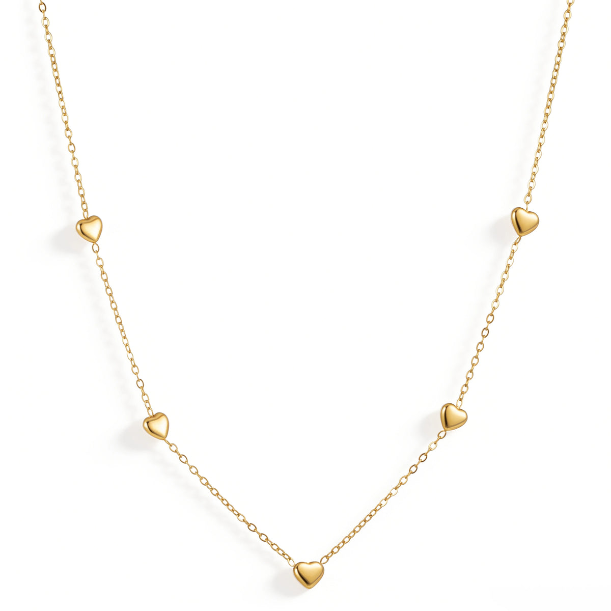 Gold necklace featuring small polished hearts spaced along a fine chain, shown on a white background.