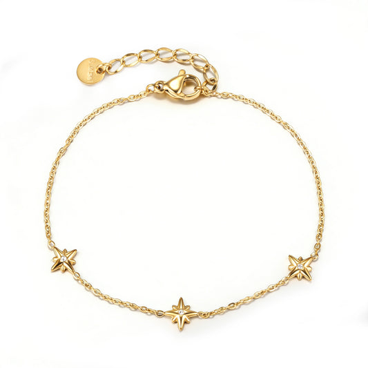 Gold bracelet featuring three sculpted star motifs spaced along a fine chain, shown on a white background.